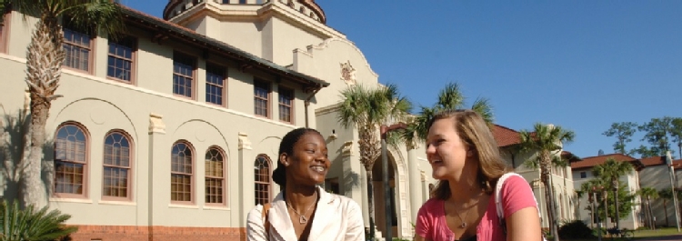 Photo of two students walking across the Front Lawn of Valdosta State University